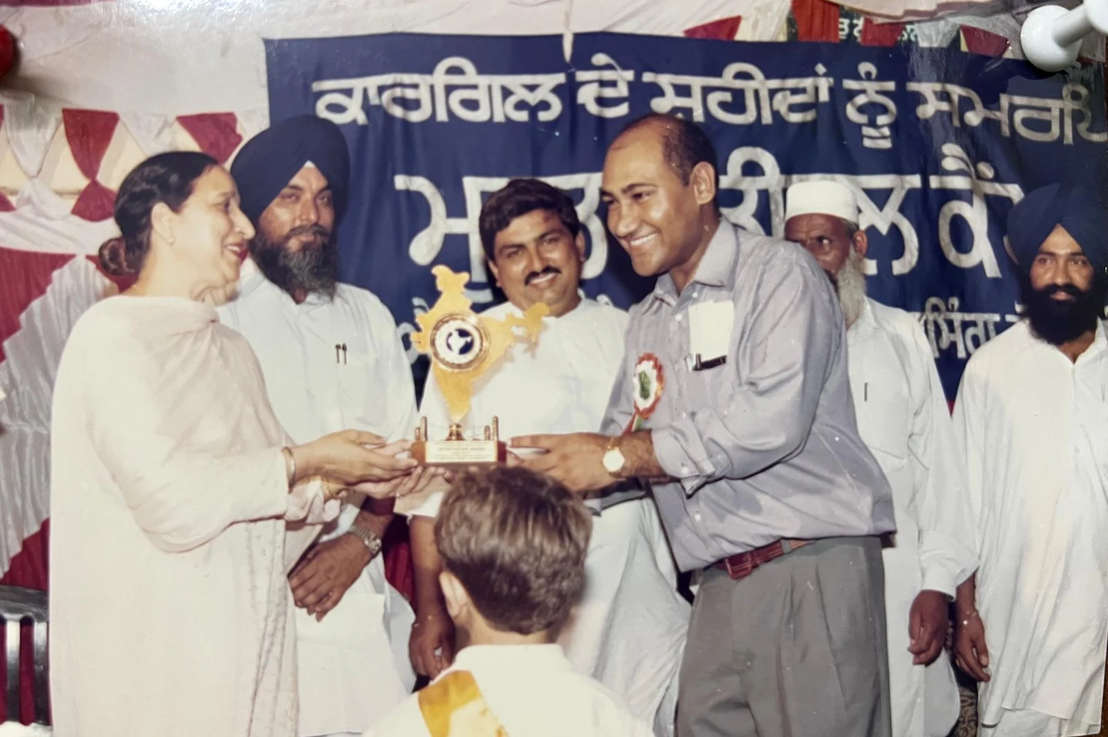 Award presentation on community event stage