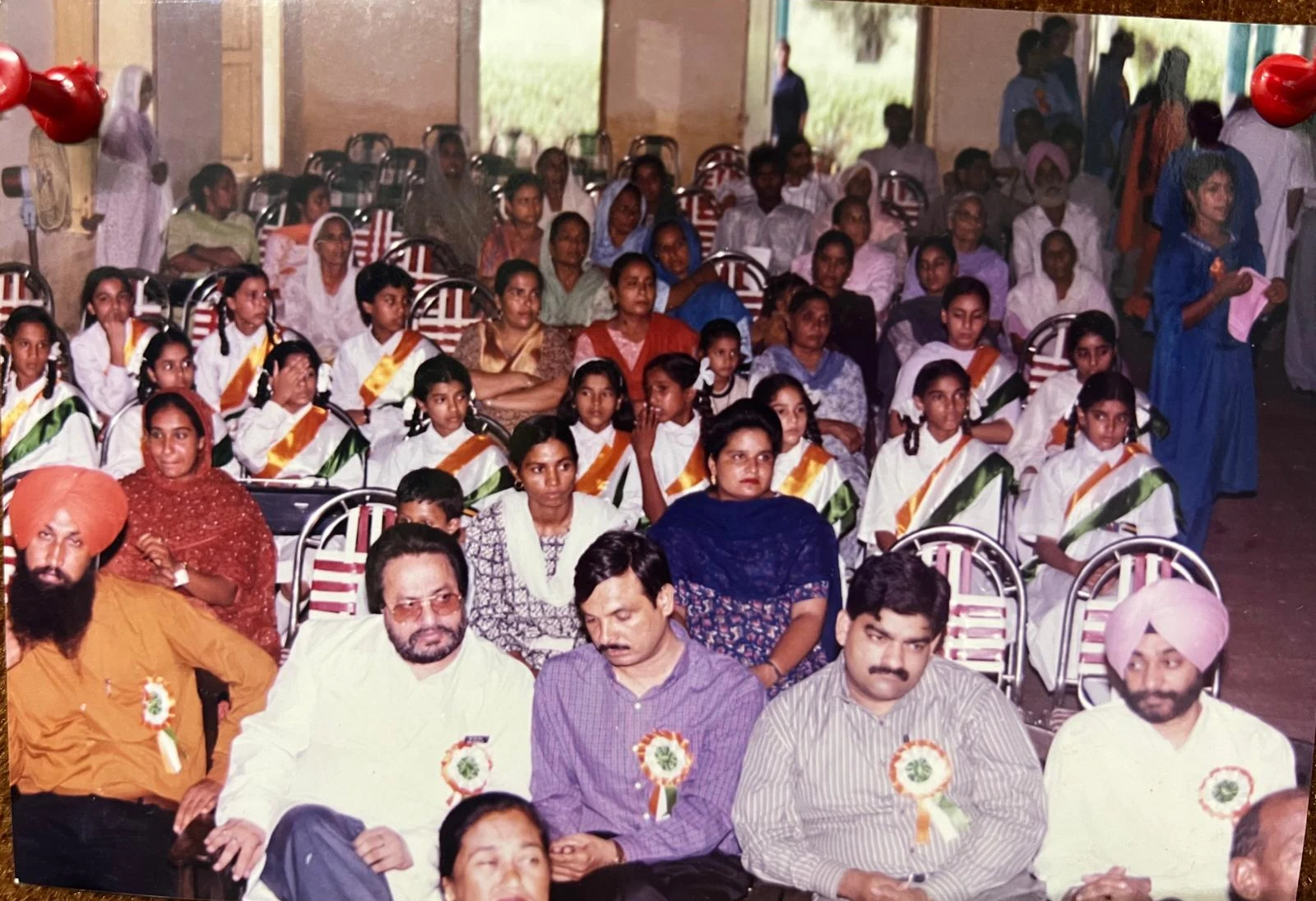 Community audience and students seated at an event