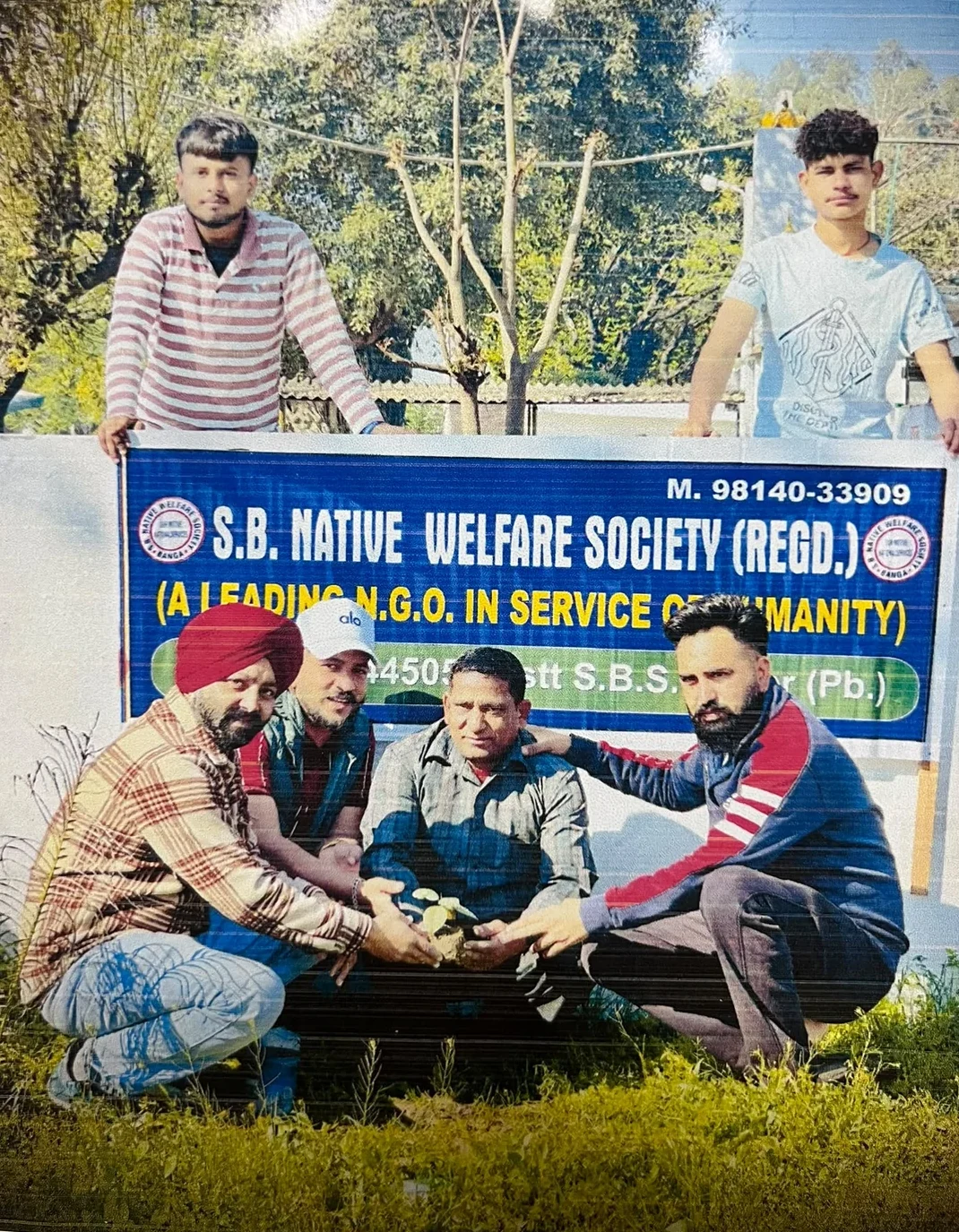 Tree plantation activity with S.B. Native Welfare Society banner